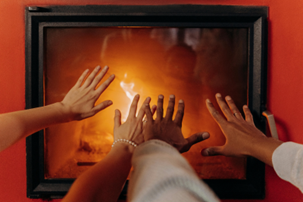 Hands reaching for warmth in Southlake while waiting for furnace repair