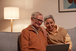 An elderly couple browsing a computer in a home recently made warm again by Southlake furnace repair