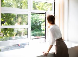 Woman leaning out the window looking for cleaner air in Southlake