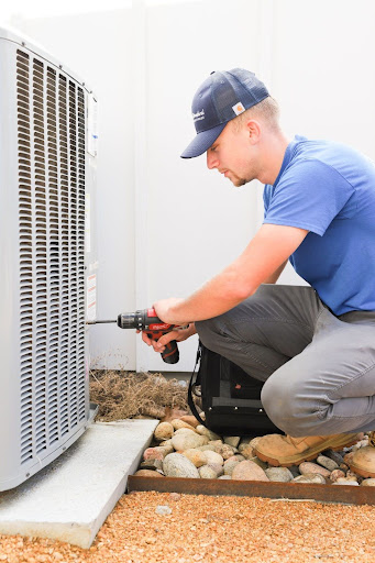 AC & Heat Solutions technician repairing an air conditioning unit in Trophy Club